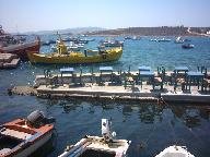 Boats in Aliki harbour. You can have dinner in the sea!